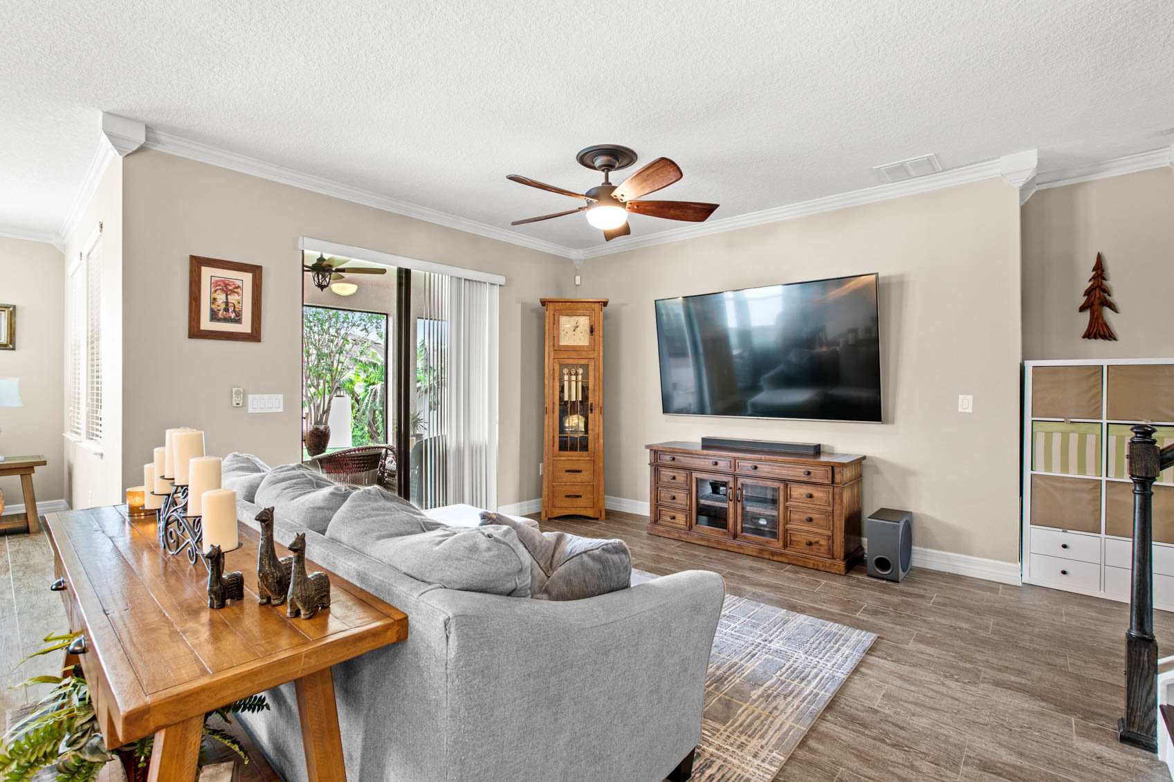 living room with grey sectional and mounted tv